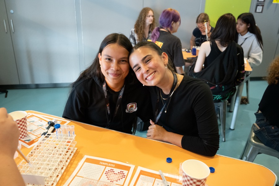 Two Kirkness Scholars smiling during a hands-on activity