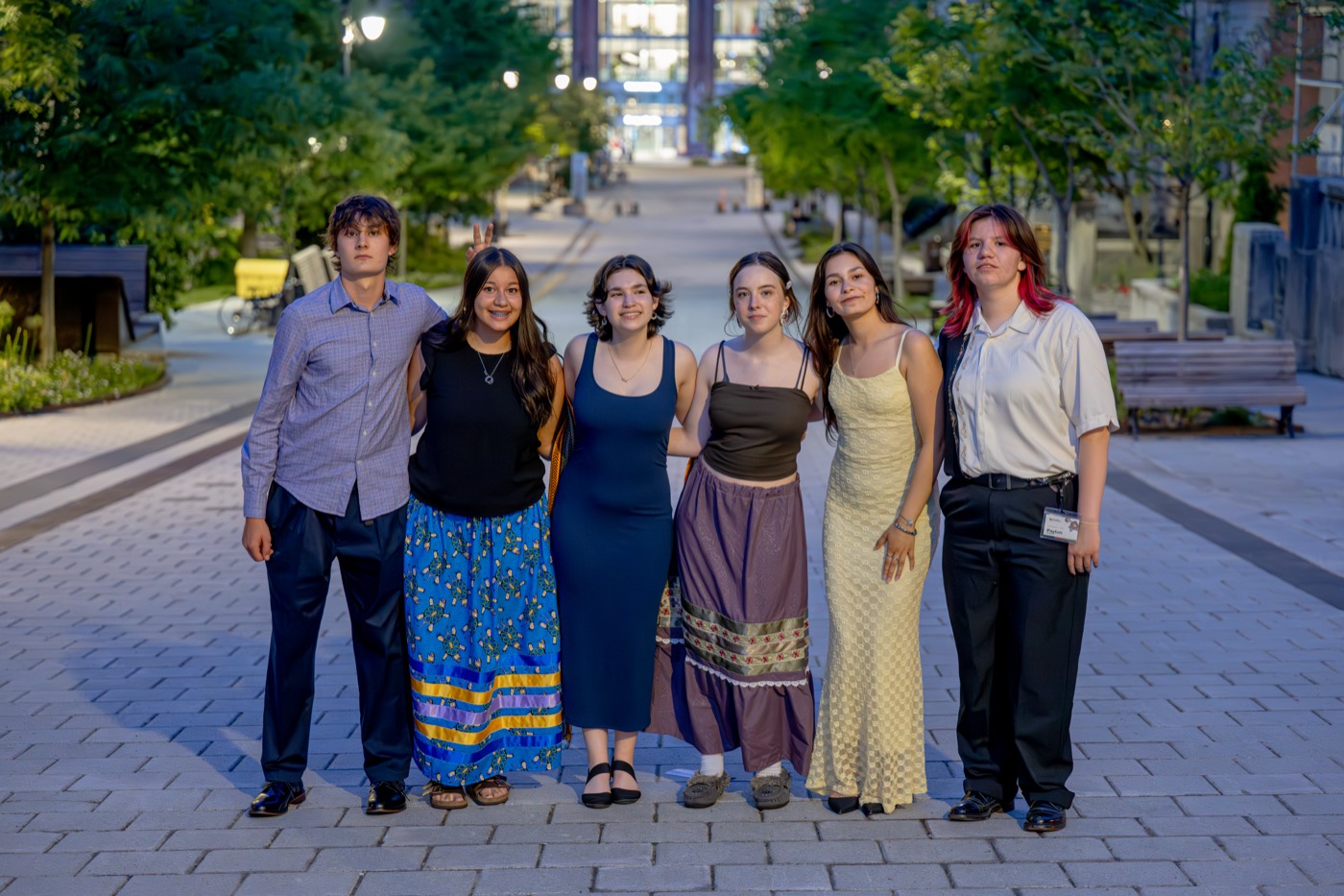Six Kirkness Scholars together on campus at dusk before the honour dinner