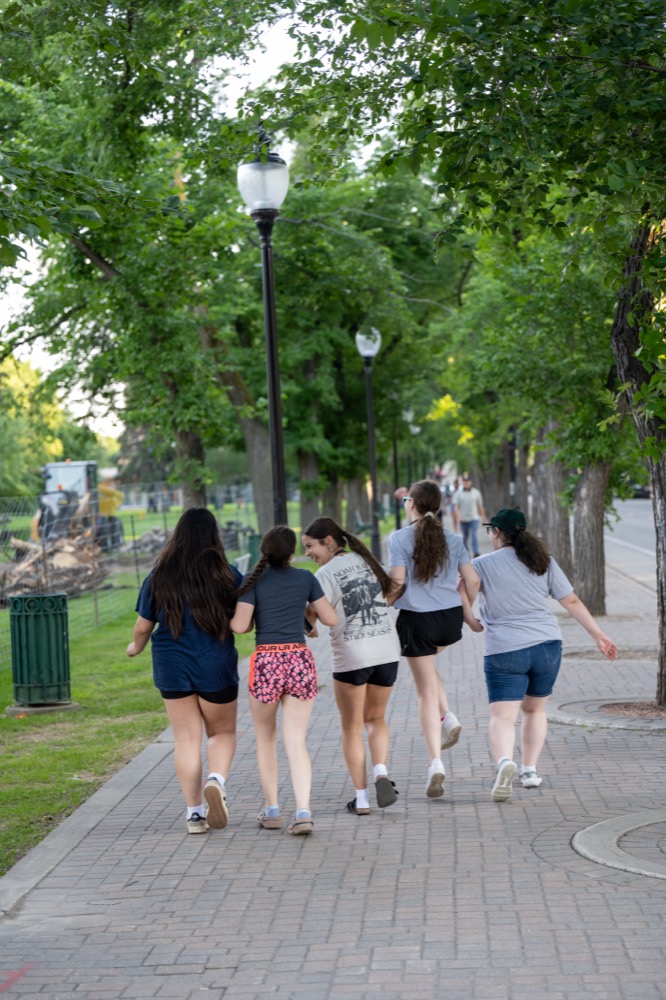 Kirkness Scholars walking together along a tree-lined campus path