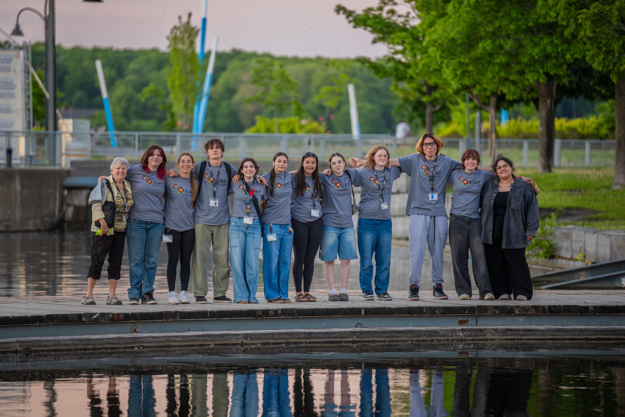 Kirkness Scholars and staff standing together at sunset